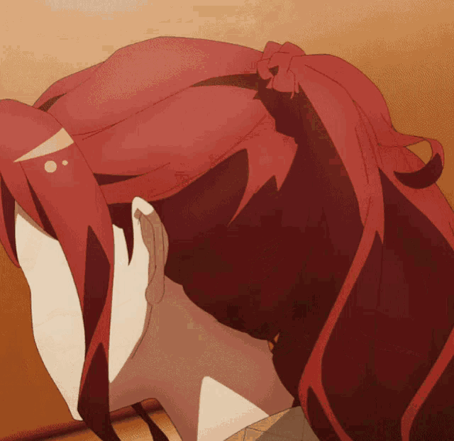 a woman with red hair is covering her face with her hands