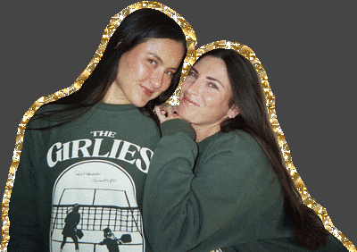 two women wearing sweatshirts that say the girlies are posing for a picture