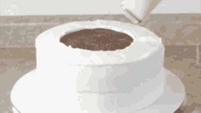 a cake with a hole in the middle is being frosted