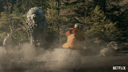 a statue of a lion in a forest with a netflix logo