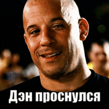 a bald man is smiling in front of a sign that says " dzn proshuyus "