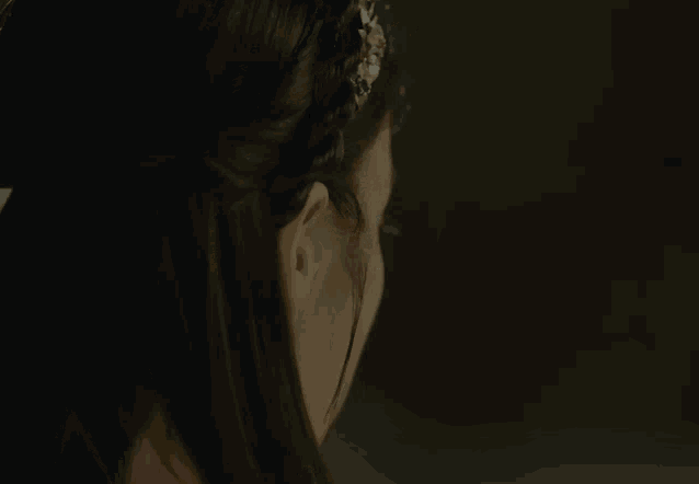 a close up of a woman 's face wearing a headband