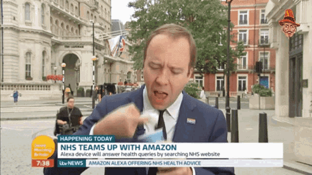 a man in a suit and tie is being interviewed on a tv show about nhs teams up with amazon