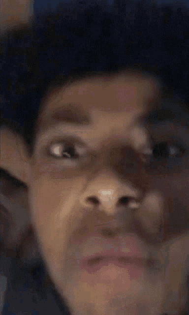 a close up of a person 's face with a blurry background .