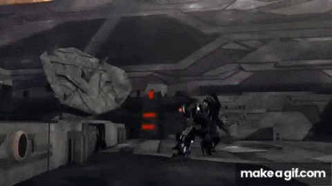 a robot is standing in a room with a rock in the background .