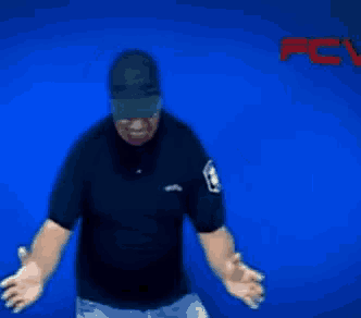 a man wearing a hat and sunglasses is dancing in front of a blue background with the word pc on it