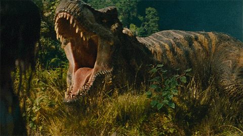 a dinosaur with its mouth wide open standing in the grass