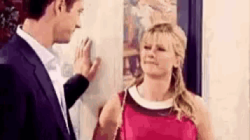 a man and a woman are touching each other 's faces .