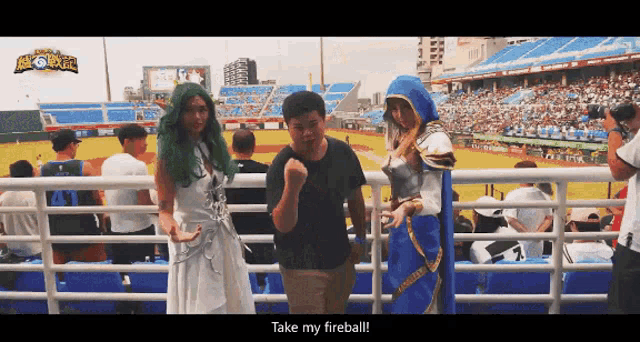 a man in a black shirt stands next to a woman in a white dress and the words take my fireball