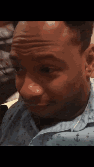 a man in a blue shirt with anchors on it