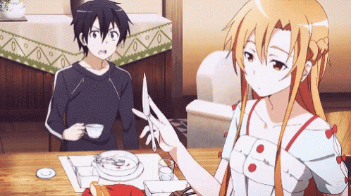 a man and a woman are sitting at a table with a plate of food .