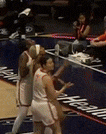 a group of basketball players are standing on a court in front of a banner that says washington