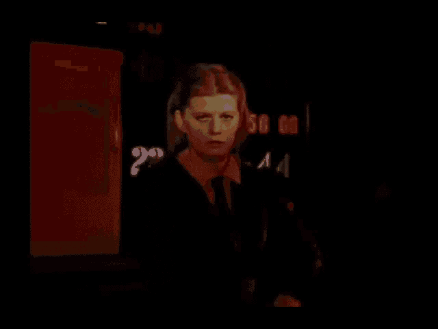 a woman standing in front of a sign that says ' telephone ' on it