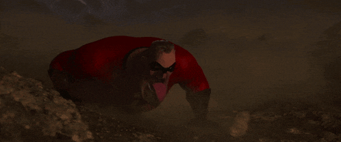 a man in a red superhero outfit is crawling on the ground