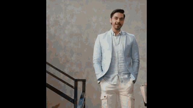 a man in a blue jacket and white pants is yawning while holding a laptop