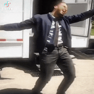 a man is dancing in front of a trailer .