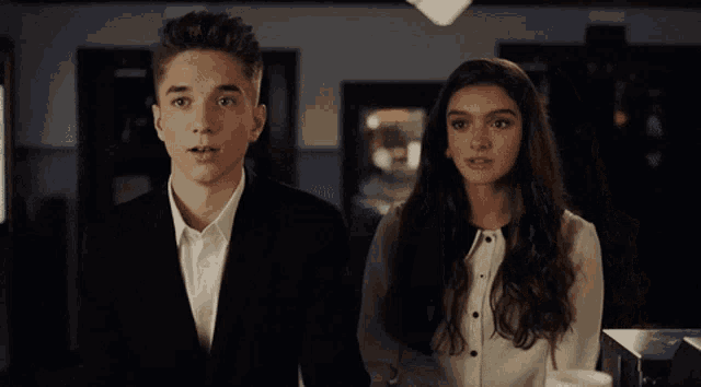 a man and a woman are standing next to each other