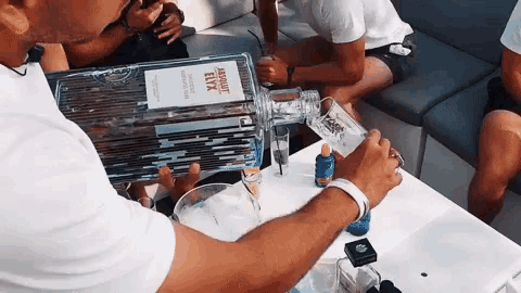 a man is pouring a drink from a bottle of miguel elyx