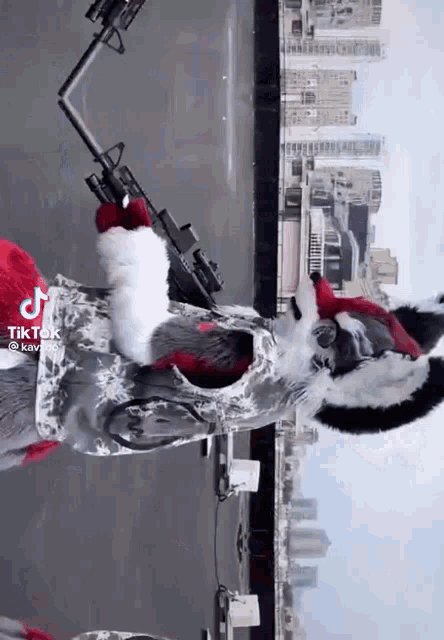 a person in a fursuit is holding a gun on a rooftop .