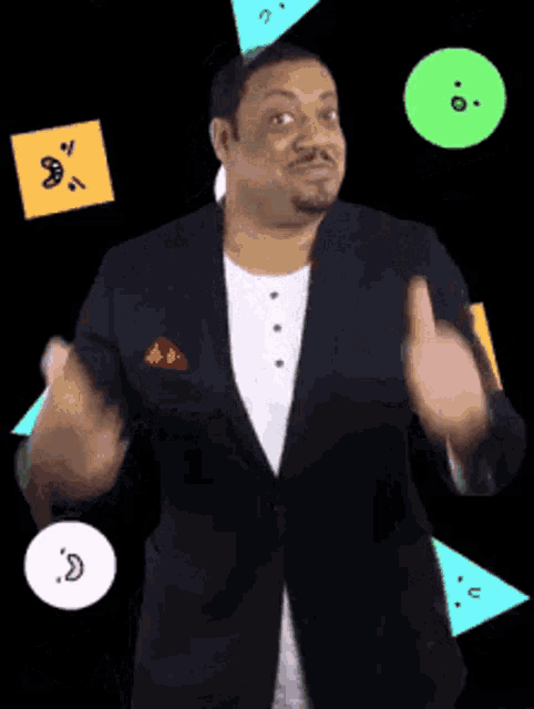 a man in a suit is standing in front of a black background with smiley faces on it .