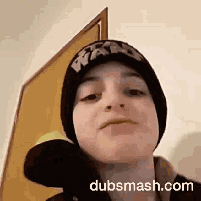 a person wearing a beanie and a tennis ball with dubsmash.com written on the bottom