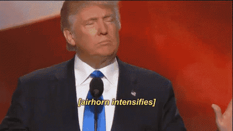 a man in a suit and tie is speaking into a microphone and says airhorn intensifies