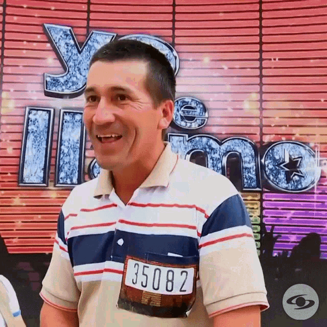 a man in a striped shirt has a tag on his pocket that says 35082