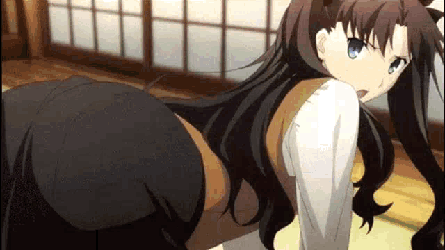 a girl in a white shirt and black skirt is sitting on the floor in a room .