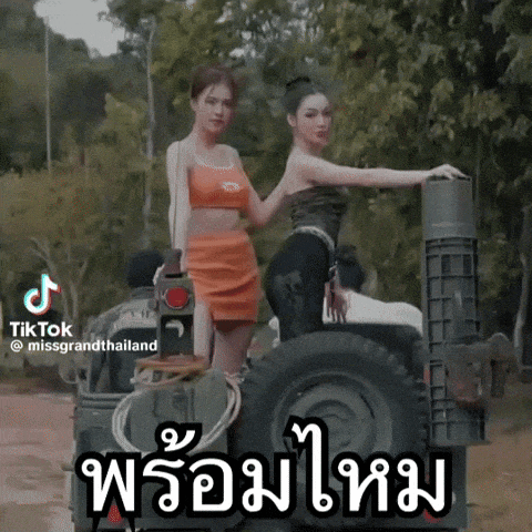 two women are standing on the back of a military vehicle with tiktok written on the bottom right