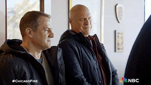 two men standing next to each other with the hashtag #chicagofire on the bottom right