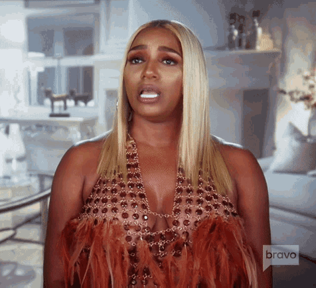 a woman wearing a feathered dress is featured on bravo