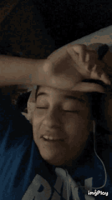 a girl wearing headphones and a blue shirt with the word pa on it