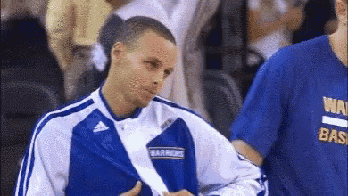 a man wearing a blue and white jacket with the word warriors on it .
