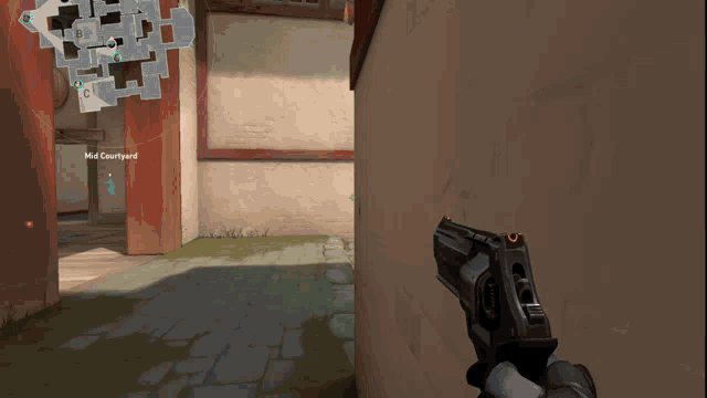 a person is holding a gun in front of a wall that says mid courtyard on it