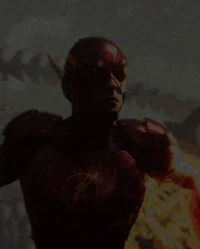 a man in a red superhero costume with a flash logo on his chest