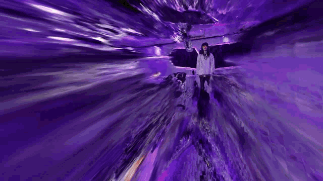 a person standing in a purple room with a purple background