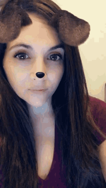 a woman wearing a snapchat filter that looks like a dog nose