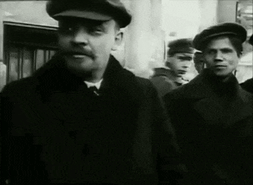 a man with a mustache is standing in a line with other men wearing hats .
