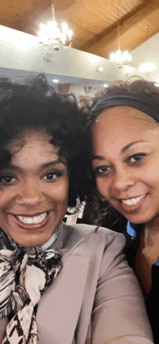 two women are posing for a picture and smiling at the camera