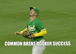 a baseball player wearing a green jersey that says island on it