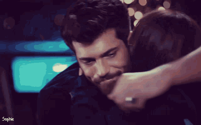 a man and a woman hugging with the name sophie on the bottom