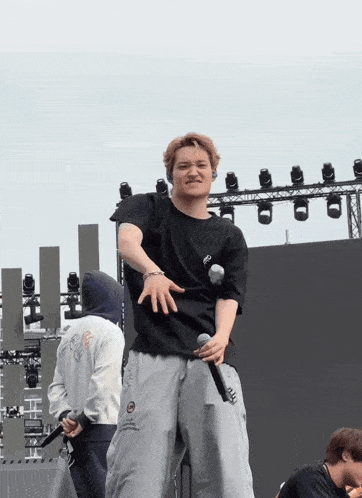 a man wearing a black shirt that says ' a ' on it