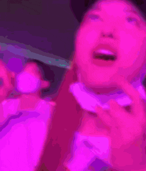 a blurry picture of a person 's face with purple lighting