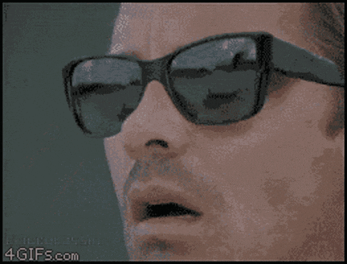 a close up of a person wearing sunglasses with a 4gifs.com watermark on the bottom