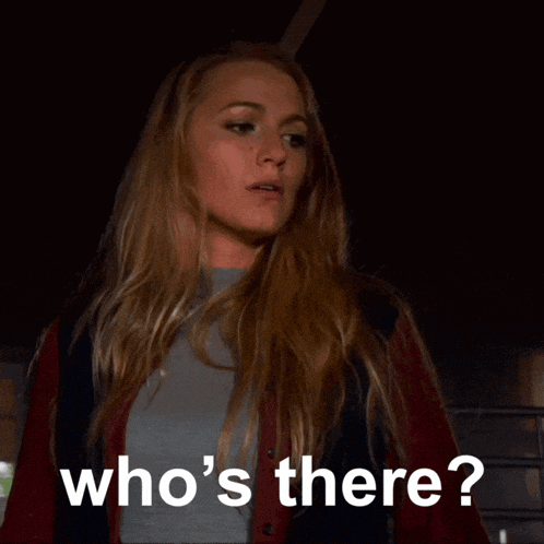 a woman is asking who 's there in a dark room