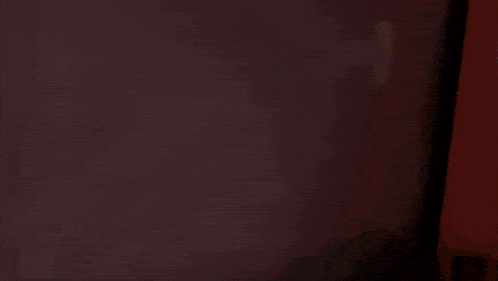 a blurred image of a shelf with a red book that says ' i love you ' on it