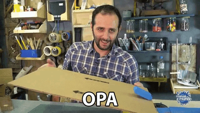 a man in a plaid shirt is holding a piece of cardboard with the word opa written on it
