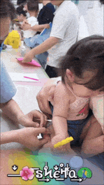 a little girl is being examined by a doctor with the name sheita on the bottom right
