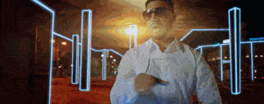 a man wearing sunglasses and a white shirt stands in front of a neon sign that says volkswagen