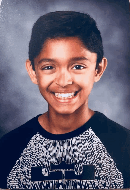 a young boy wearing a black and white shirt that says lbj